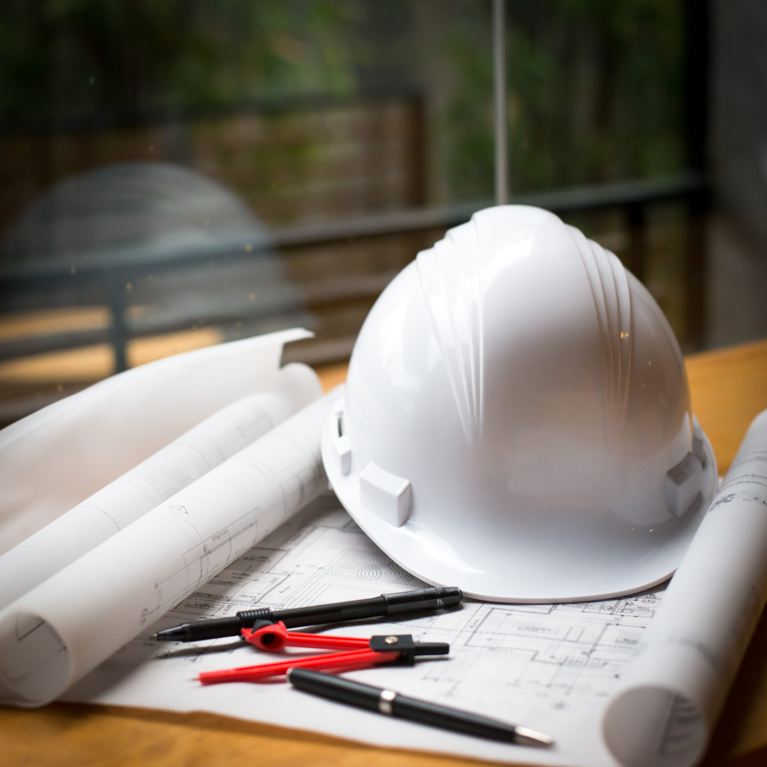 construction concept image helmet rolled blueprints on wooden bo construction concept image helmet rolled blueprints on wooden boards in retro style.